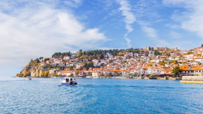 Boats riding by townscape of Lake Ohrid, North Macedonia